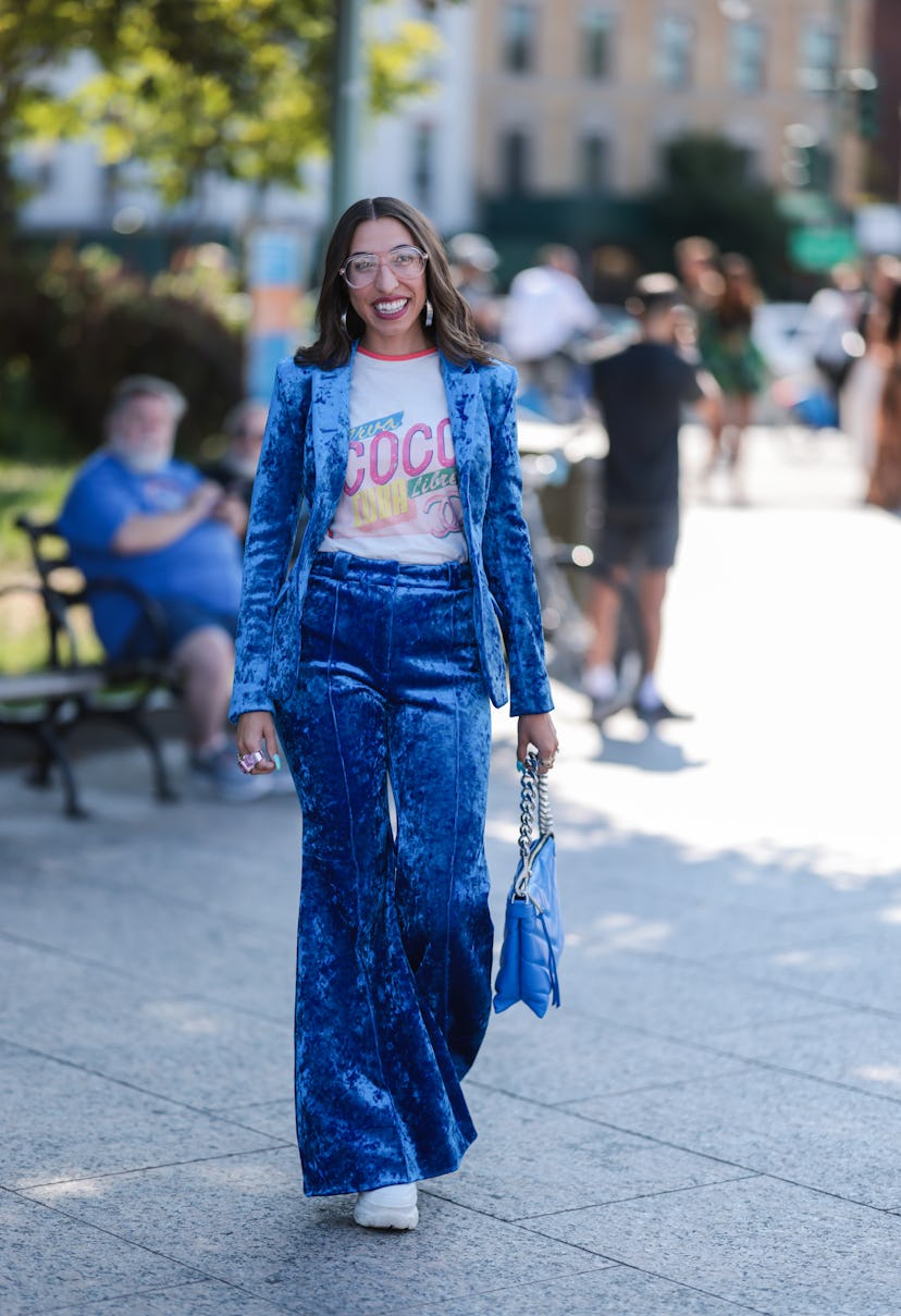 Attendee wearing a blue velvet suit with a T-shirt at New York Fashion Week.