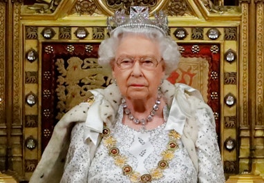 Britain's Queen Elizabeth II (L) takes her seat on the The Sovereign's Throne in the House of Lords ...