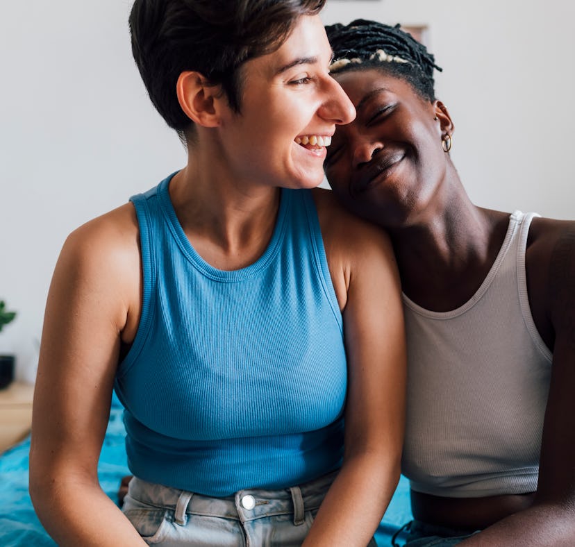 Two women cuddle and discuss the spiritual meaning of the 2022 fall equinox.