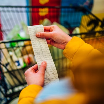 Woman looking at her grocery bill. New data from the Census Bureau shows that the expanded child tax...