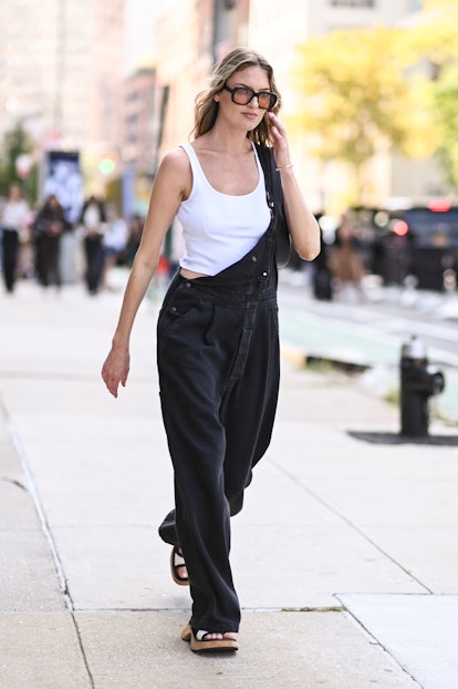 A model is seen wearing a white top, R13 overalls and black and white flats outside the Veronica Bea...
