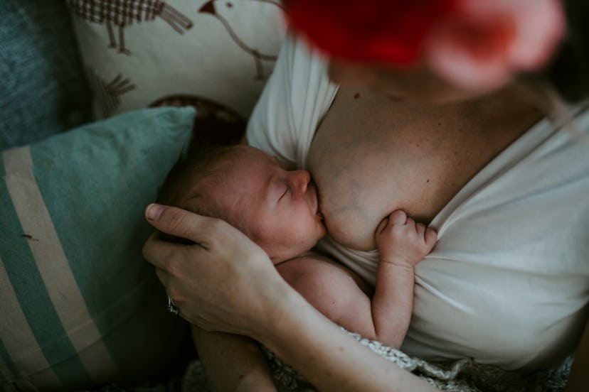 a woman breastfeeding a baby in an article about if you can breastfeed after a breast lift 