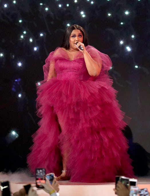 Lizzo performs onstage in a tulle gown similar to her 2022 Emmys gown during the 2019 American Music...