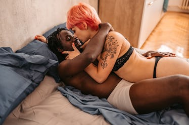 Young couple in love having a desire towards each other in their bedroom.