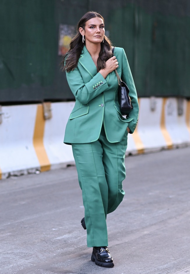 a guest in a green suit at New York Fashion Week.