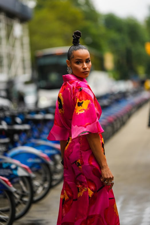 NEW YORK, NEW YORK - SEPTEMBER 12: A guest wears a silver large earrings, a red / pink fuchsia / yel...