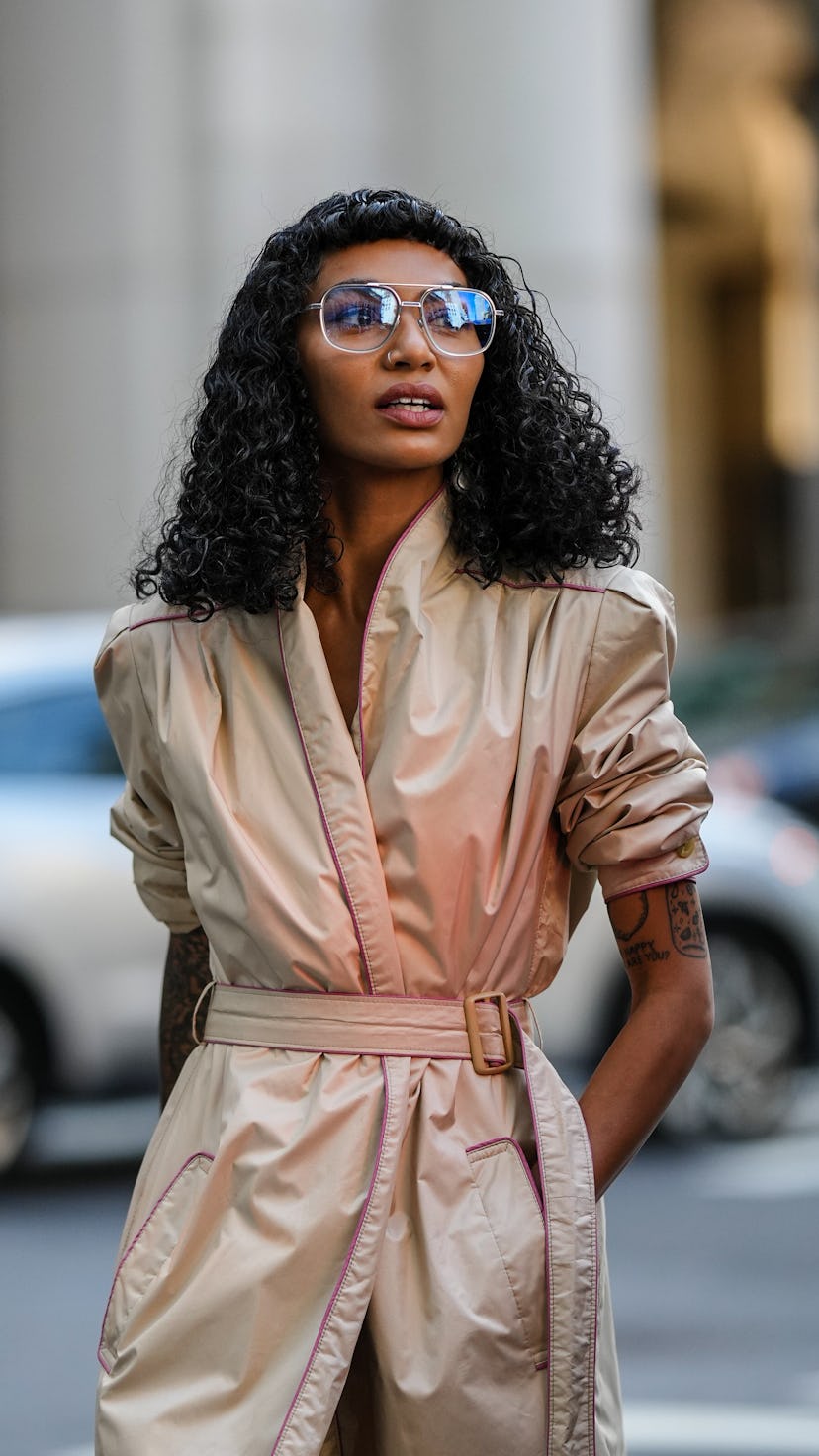 guest wears a coat as a dress street style
