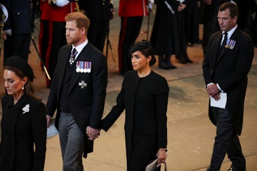 Prince Harry and Meghan arrived in the Palace of Westminster after the procession of Queen Elizabeth...
