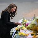 TOPSHOT - Britain's Catherine, Princess of Wales looks at floral tributes outside Norwich Gate on th...
