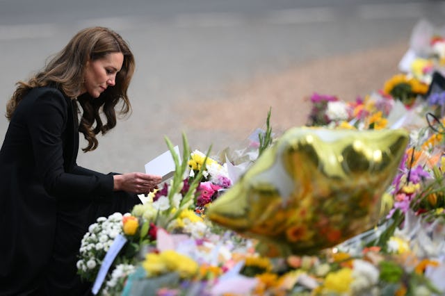 TOPSHOT - Britain's Catherine, Princess of Wales looks at floral tributes outside Norwich Gate on th...