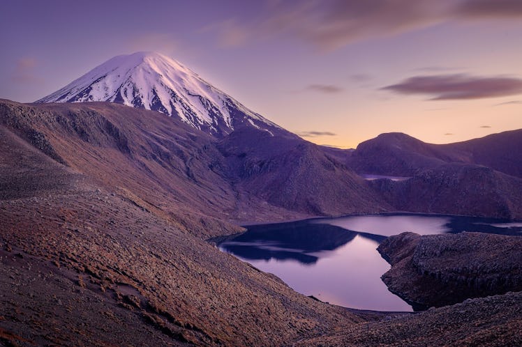 The glowing conical peak of Mount Ngauruhoe in the early morning with the Upper Tama Lake in the for...