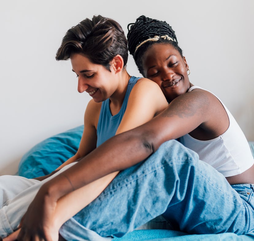 Two lesbian girls hugging in bed