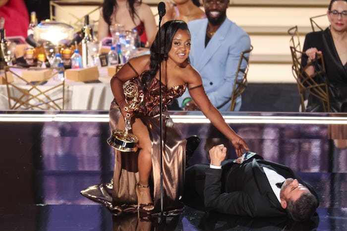 Jimmy Kimmel lies onstage as Quinta Brunson accepts the award for Outstanding Writing For A Comedy S...