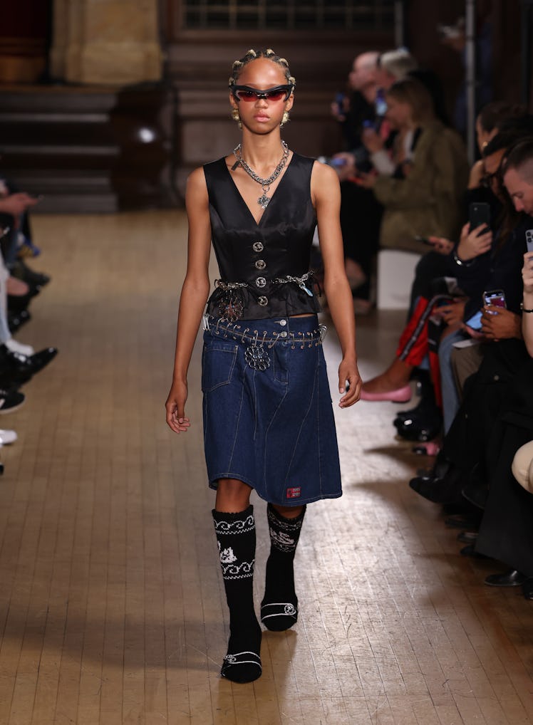A model walking the runway in a black top and denim skirt at the Chopova Lowena show during London F...