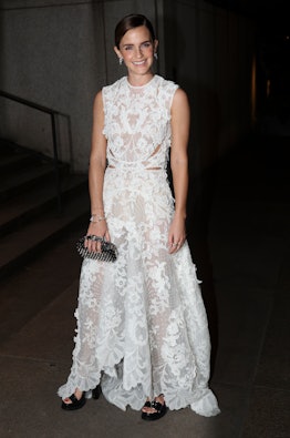 Emma Watson wearing a white sheer lace dress.