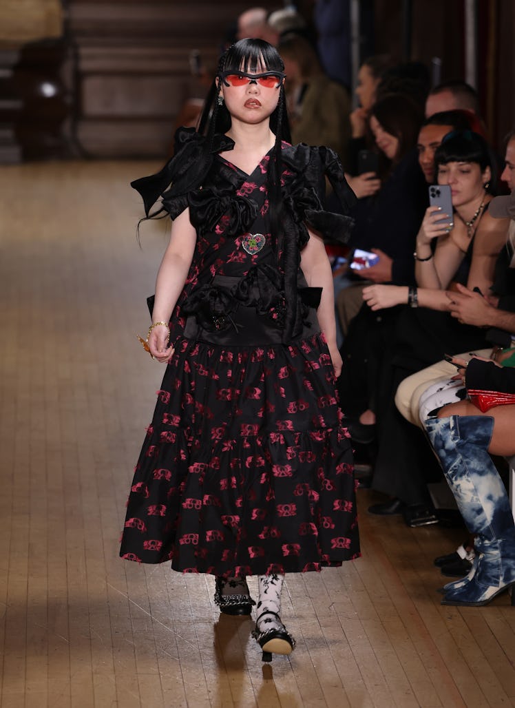 A model walking the runway in a black floral dress at the Chopova Lowena show during London Fashion ...