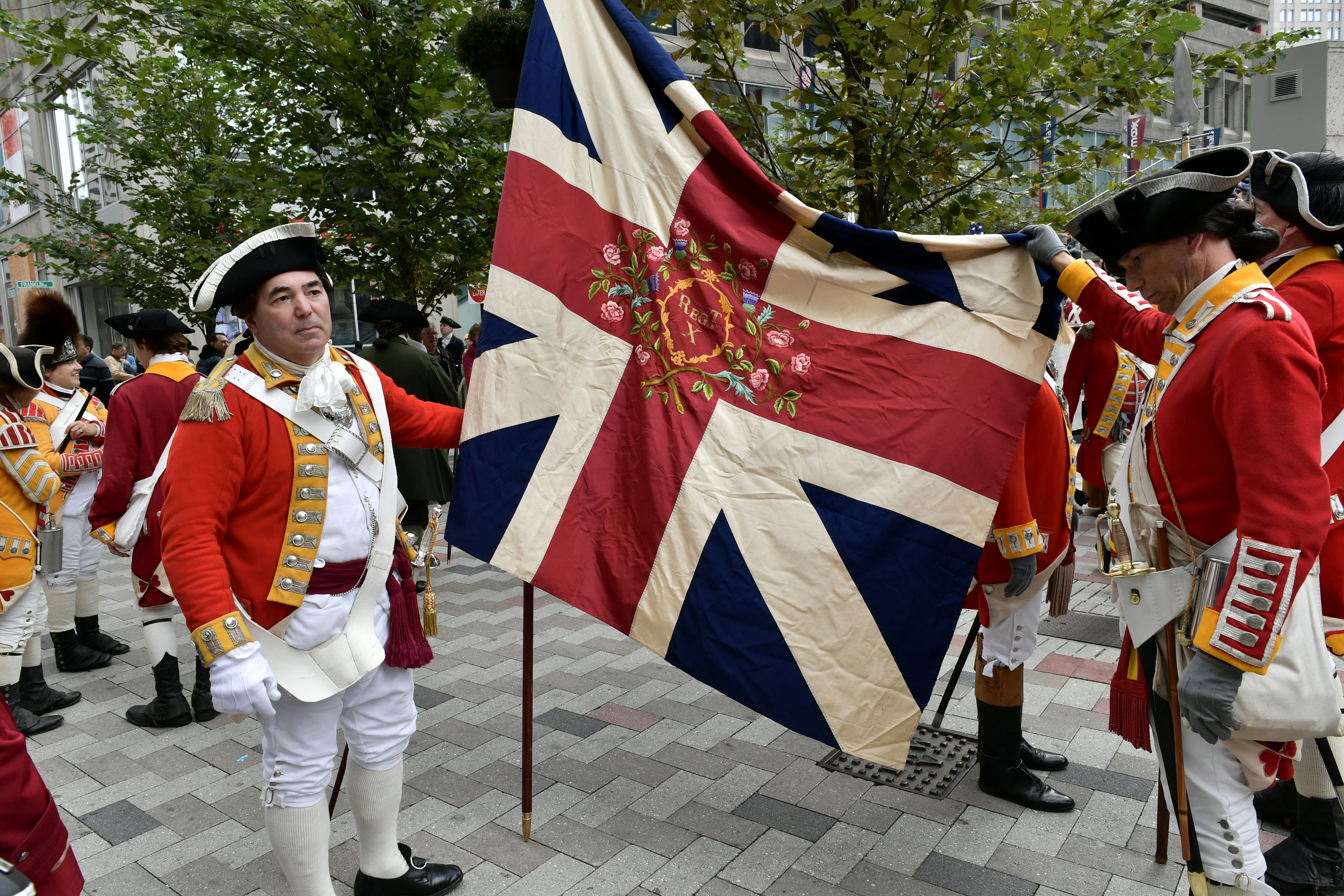 BOSTON, MA - OCTOBER 06:  Re-enactors hold a regimental flag made of silk given to them by Queeen El...