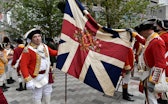 BOSTON, MA - OCTOBER 06:  Re-enactors hold a regimental flag made of silk given to them by Queeen El...
