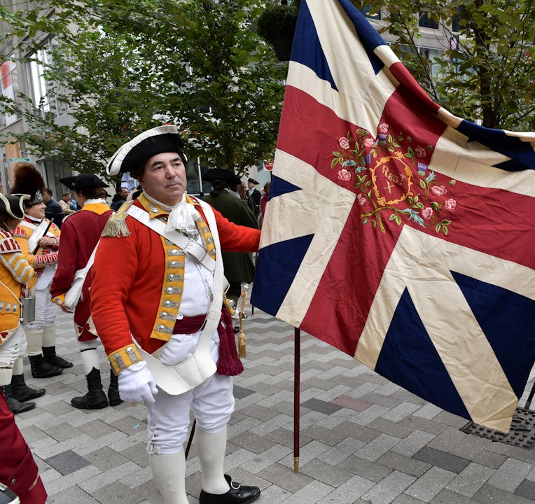 BOSTON, MA - OCTOBER 06:  Re-enactors hold a regimental flag made of silk given to them by Queeen El...