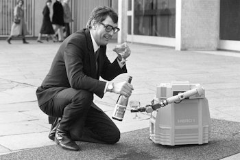 Allan Hargreaves pours a glass of wine, with the help of his new co presenter 'Hero 1', a domestic R...