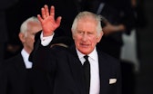King Charles III waves to the crowd as he leaves the Senedd in Cardiff, after a visit to receive a M...