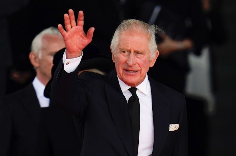 King Charles III waves to the crowd as he leaves the Senedd in Cardiff, after a visit to receive a M...