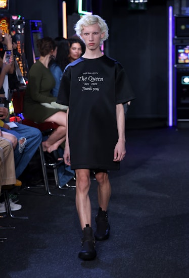 A model walking the runway while wearing a tribute to Queen Elizabeth II on their t-shirt at the JW ...