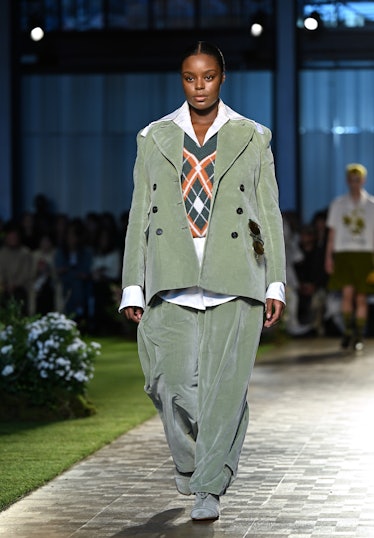 A model walking the runway in a green blazer and green pants during the S.S. Daley show during the L...
