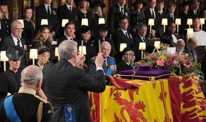 The Lord Chamberlain ceremonially breaks his Wand of Office on the coffin during the Committal Servi...