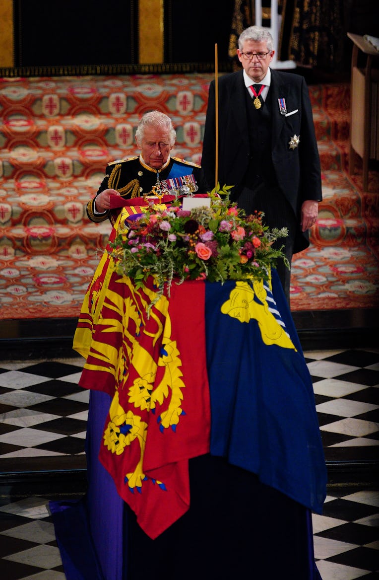 WINDSOR, ENGLAND - SEPTEMBER 19: King Charles III places the the Queen's Company Camp Colour of the ...