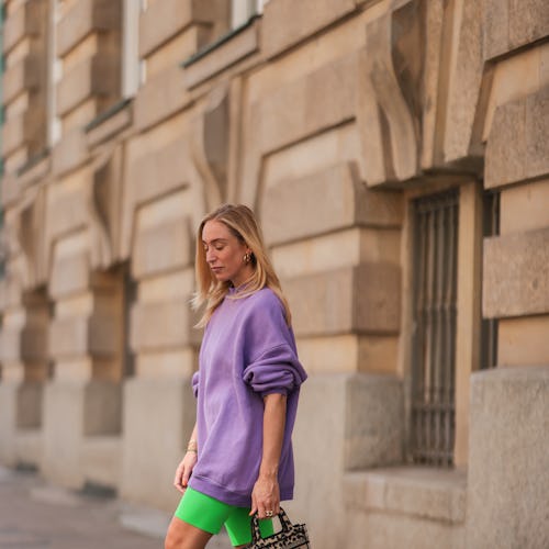 BERLIN, GERMANY - AUGUST 16: Sonia Lyson wears neon green Zara biker shorts, Amina Muaddi green heel...