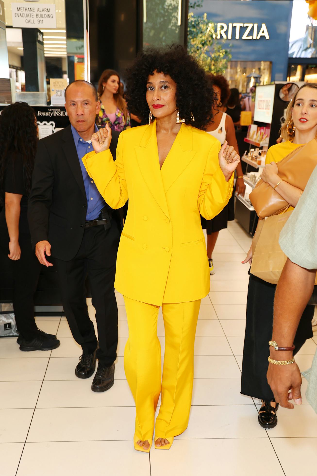 Tracee Ellis Ross in a bright yellow suit.