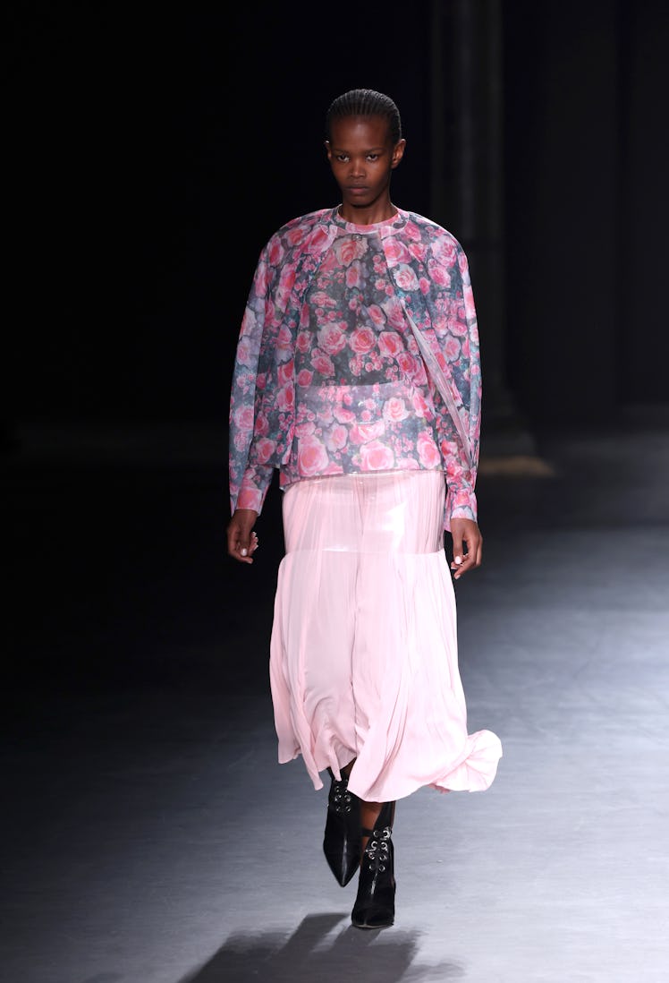 A model walking the runway in a pink floral dress at the Christopher Kane show during London Fashion...