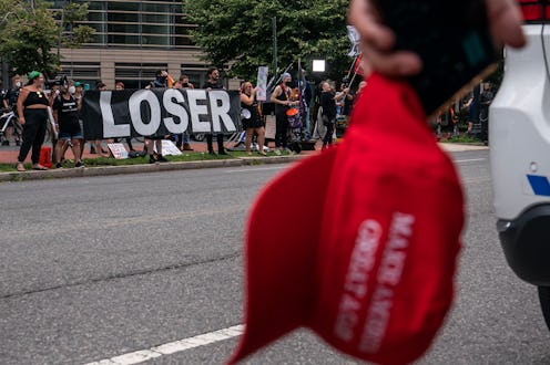 WASHINGTON, DC - JULY 26: A supporter of Donald Trump watches as protesters call for the indictment ...