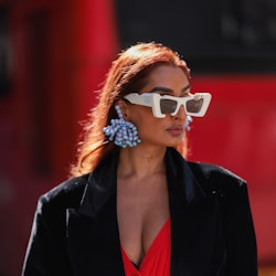 LONDON, ENGLAND - SEPTEMBER 17: Anita Chhiba is seen wearing blue statement earrings, white Off-Whit...