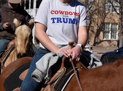 SANTA FE, NEW MEXICO - FEBRUARY 8, 2020: A teenage girl wearing a 'Cowboys for Trump' T-shirt rides ...