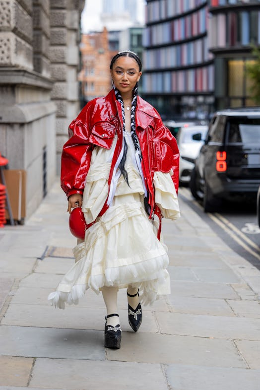 LONDON, ENGLAND - SEPTEMBER 18: Griff wears red vinyl jacket, creme white ruffled dress, black platf...