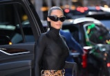 Kim Kardashian arrives to ABC's "Good Morning America" wearing tiger print pantaboots and sunglasses