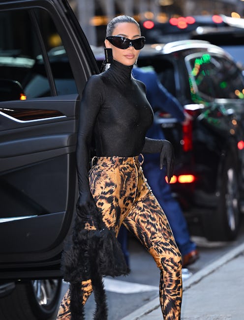 Kim Kardashian arrives to ABC's "Good Morning America" wearing tiger print pantaboots and sunglasses