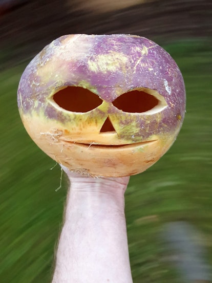 A turnip carves into a skeleton head.