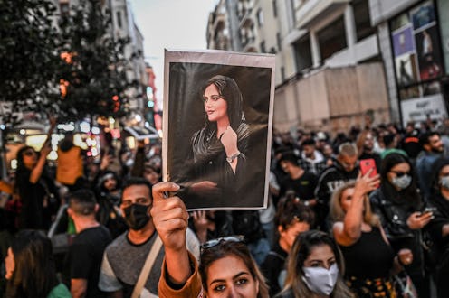 A protester holds a portrait of Mahsa Amini  during a demonstration in support of Amini