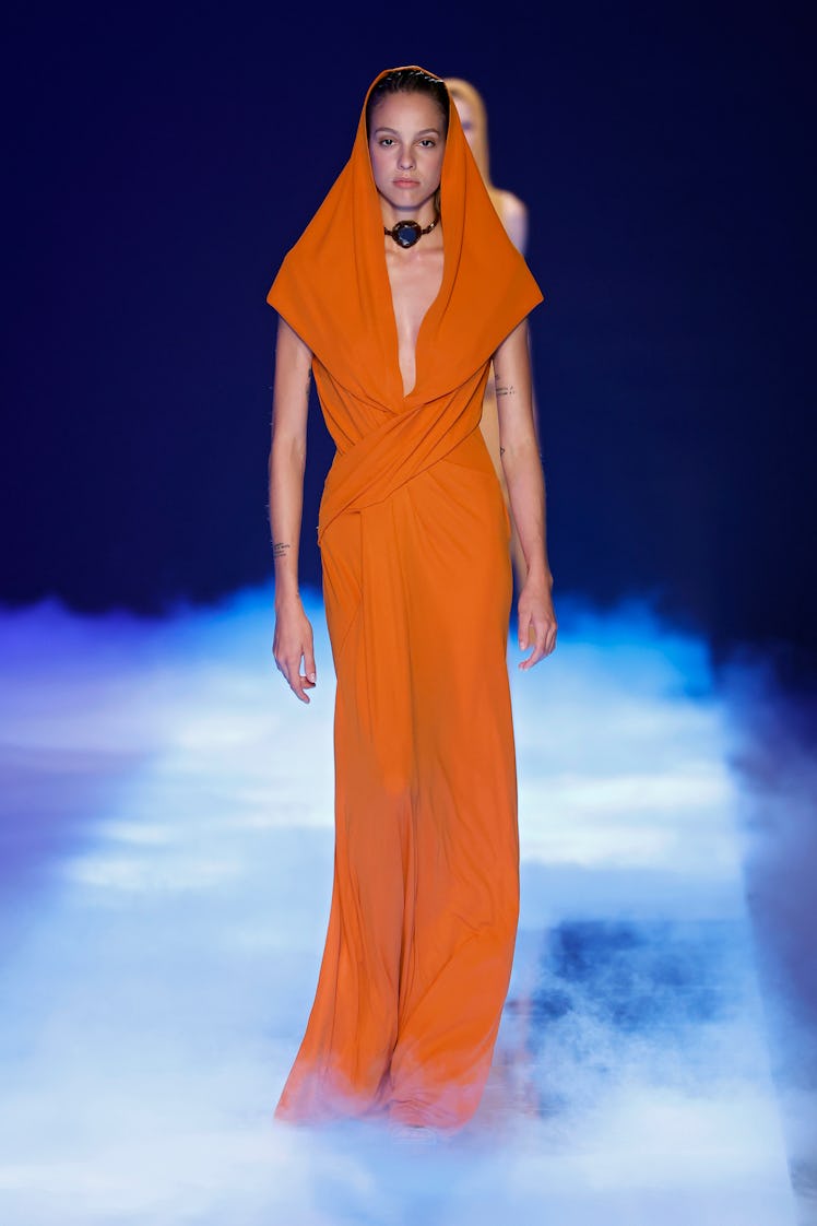 A model in Alberta Ferretti's orange jumpsuit from Spring/Summer 2023 collection