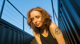 Young woman leans towards camera and gazes into lens after reading her September 26, 2022 weekly hor...