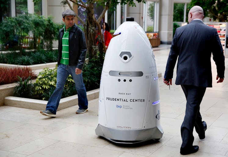 BOSTON, MA - MAY 22: People check out the Knightscope K5 security robot as it roams the Prudential C...