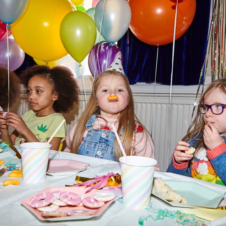 A group of young girls having fun with their friends at a birthday celebration