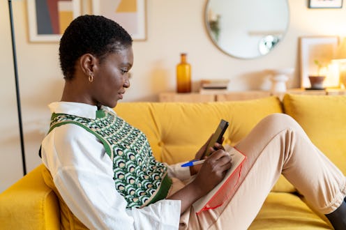 This woman is reading her daily horoscope for September 23, 2022.