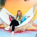 Meghan Trainor on a colorfu hammock. The singer and mom just talked to Romper about all things mothe...
