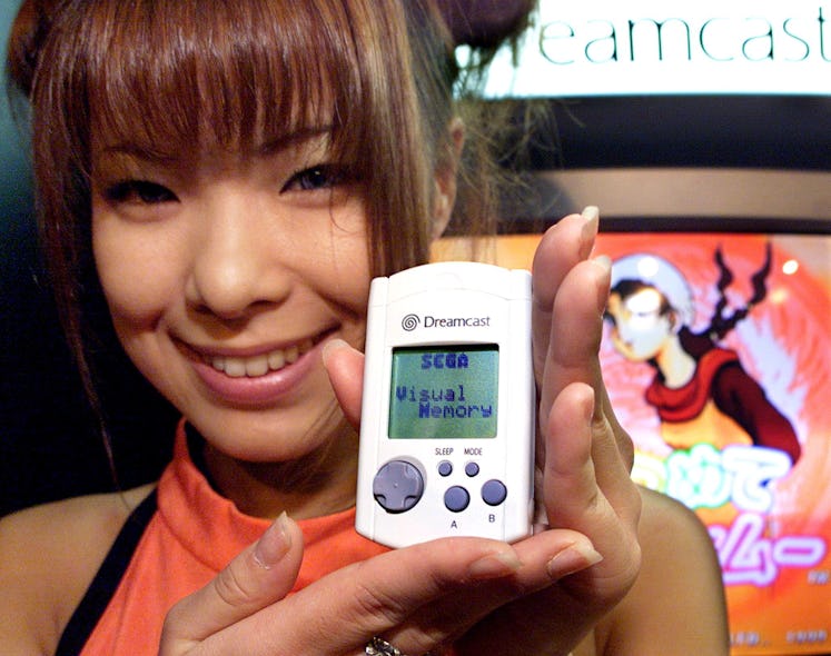 MAKUHARI, JAPAN: Japan's video game giant Sega employee Hiromi Anzai displays the portable video gam...