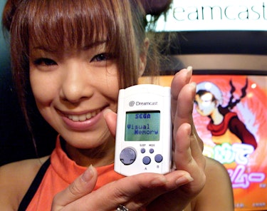 MAKUHARI, JAPAN:  Japan's video game giant Sega employee Hiromi Anzai displays the portable video ga...