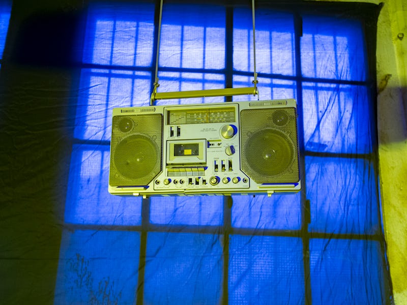 an old boom box hung beside a window at a flea market